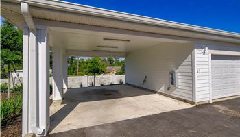The garage of a home with a driveway and a white garage door